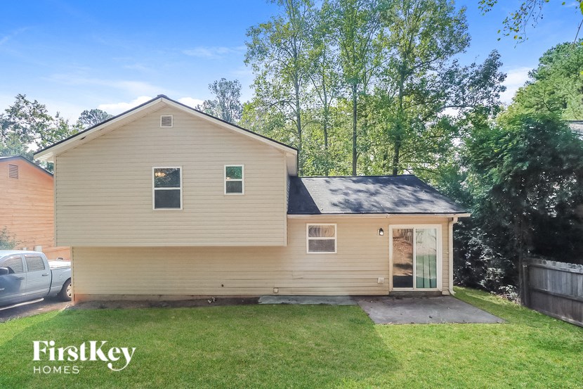 the front of a house with a lawn and a driveway