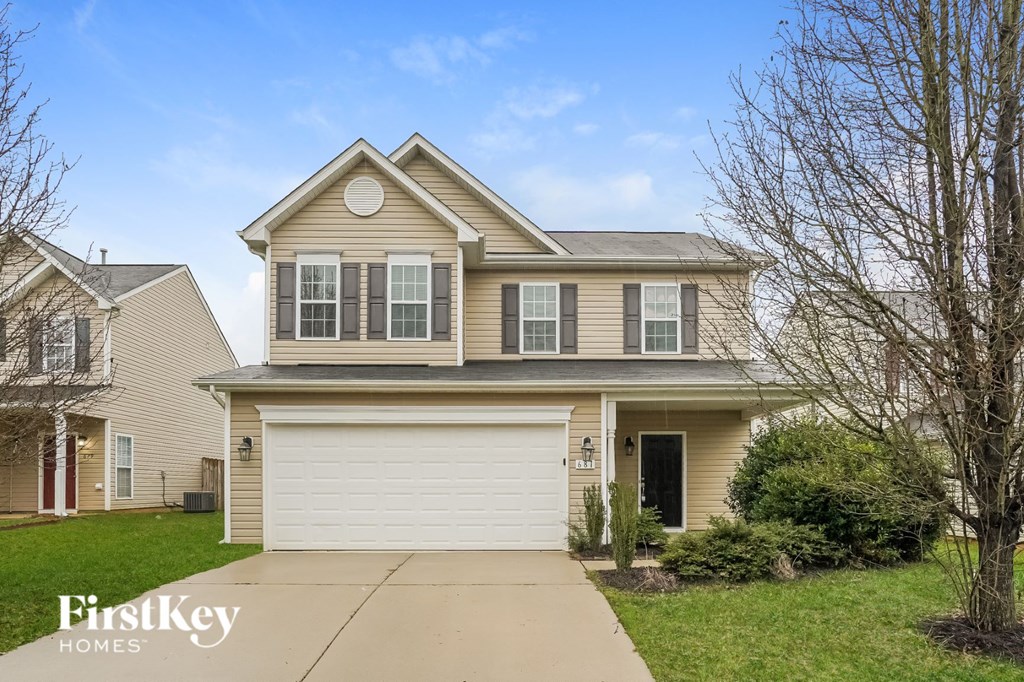 A two-story house with a garage is for sale.