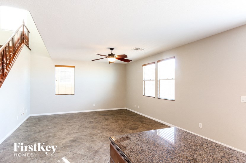 A spacious room with a fan and a window.