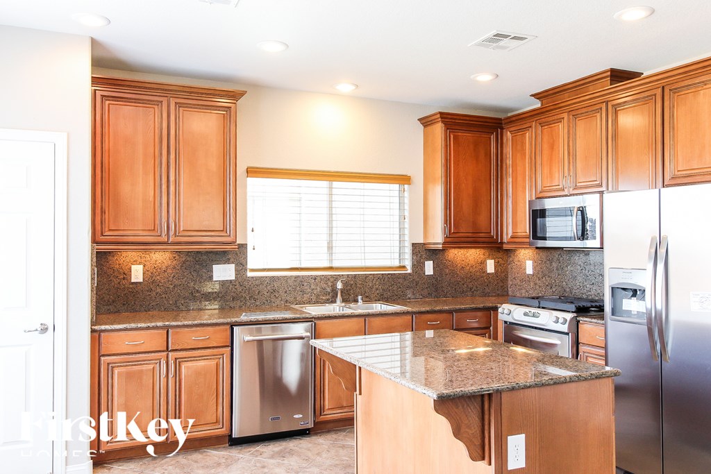 A kitchen with wooden cabinets and stainless steel appliances.