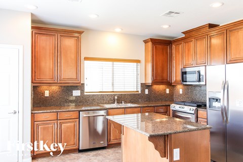 A kitchen with wooden cabinets and stainless steel appliances.