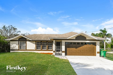 a house with a garage door and a lawn