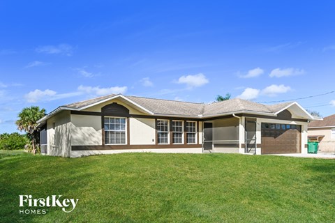 a home with a grassy yard and a house