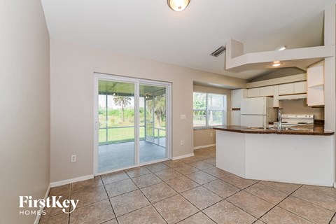 a kitchen with a sliding glass door leading to a patio