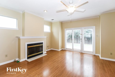 A spacious living room with a fireplace and sliding glass doors.