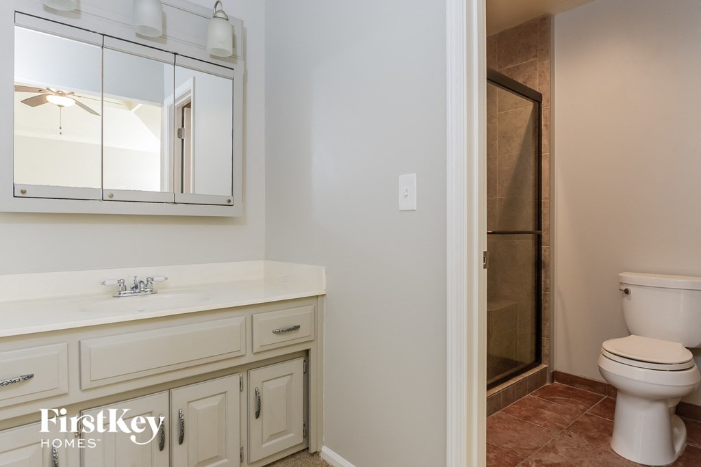 a bathroom with a sink toilet and a shower