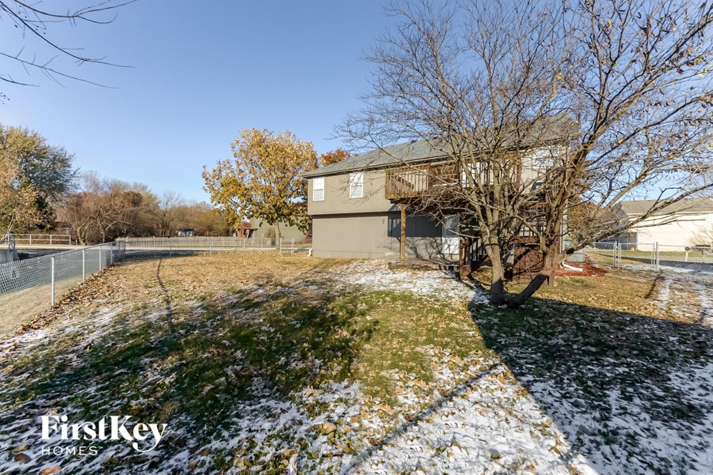 a house with a yard with snow on the ground