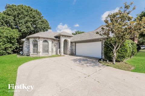 A large house with a driveway in front of it.