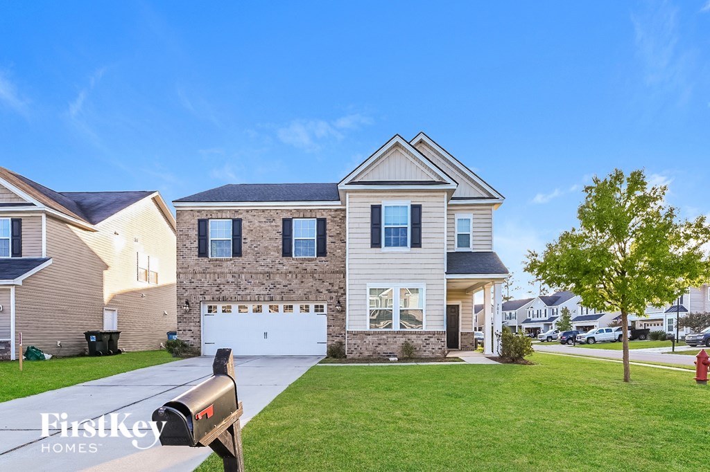 a house with a white garage door and a lawn