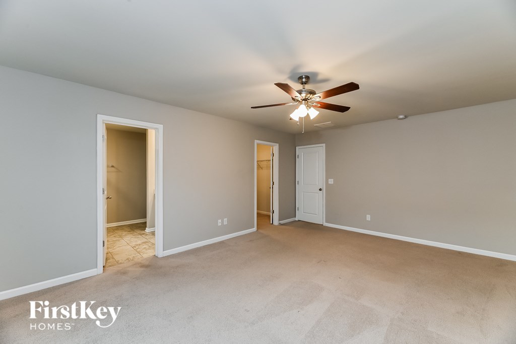 the master bedroom is spacious and has a ceiling fan