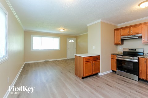 A kitchen with wooden cabinets and a stainless steel oven.