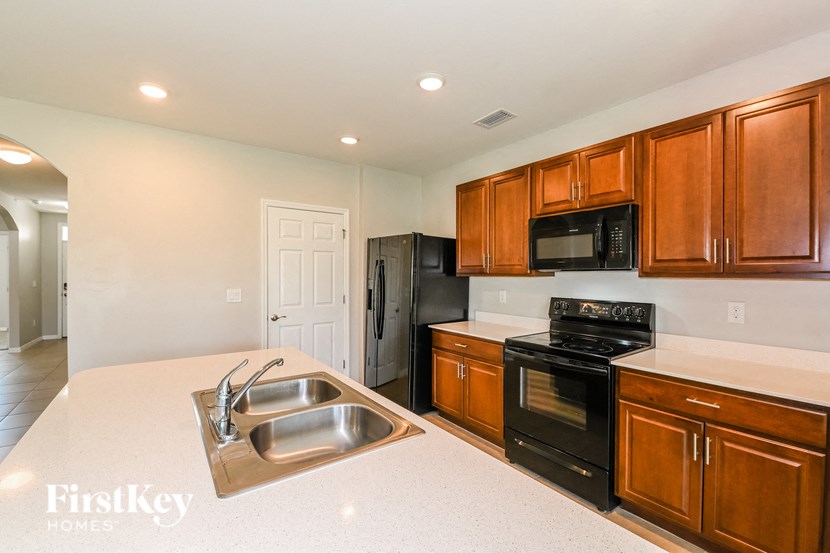 a kitchen with black appliances and white counter tops