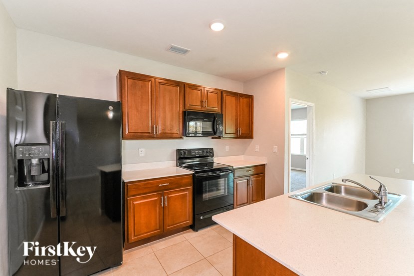 a kitchen with stainless steel appliances and wooden cabinets