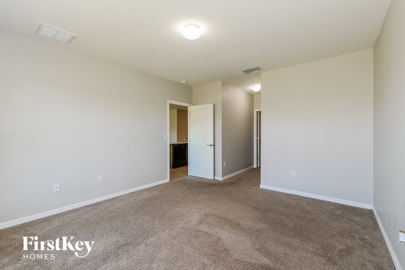 a living room with a carpeted floor and white walls