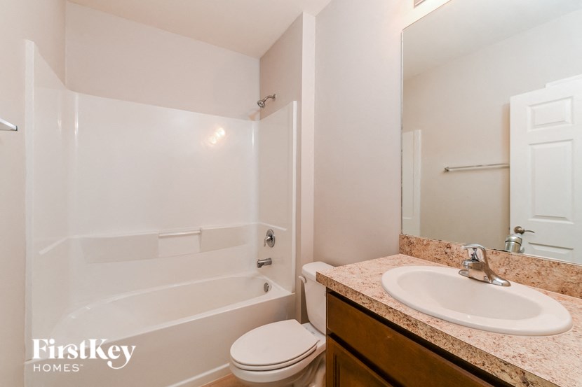 a bathroom with a sink toilet and bath tub