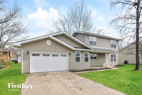 A two-story house with a garage is for sale.