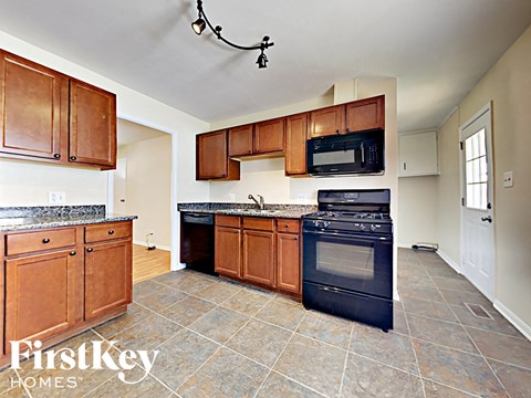 a kitchen with wooden cabinets and black appliances