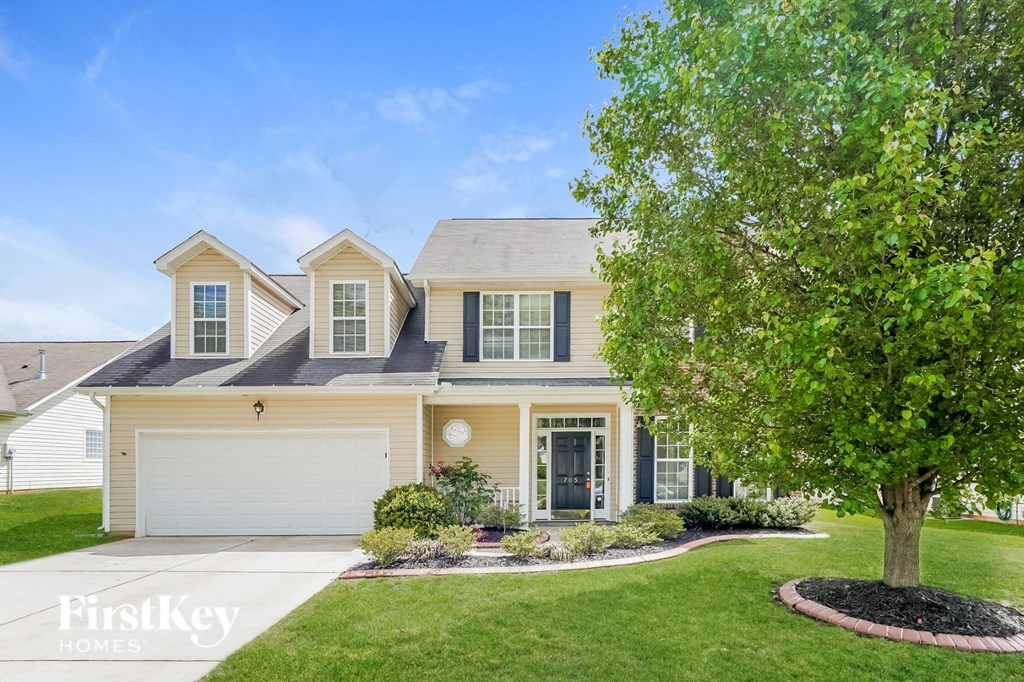A large house with a tree in front of it.