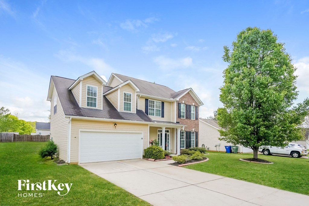 A large house with a garage is for sale by FirstKey Homes.