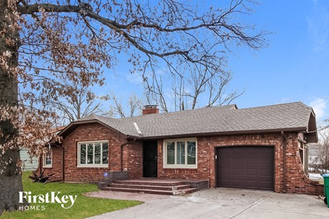 a red brick house with a black garage door