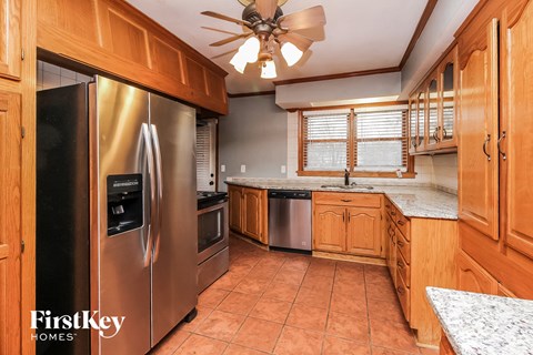 a kitchen with stainless steel appliances and wooden cabinets