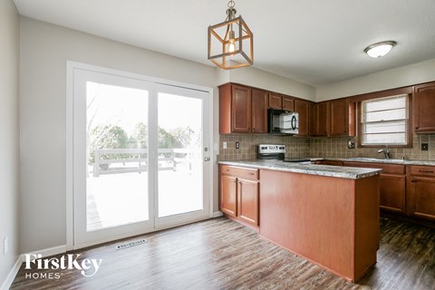 A kitchen with wooden cabinets and a large island.