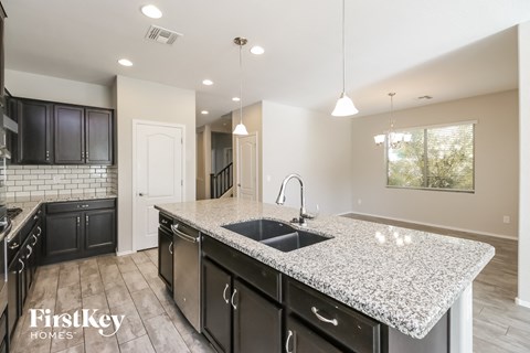 a kitchen with a granite counter top and a sink