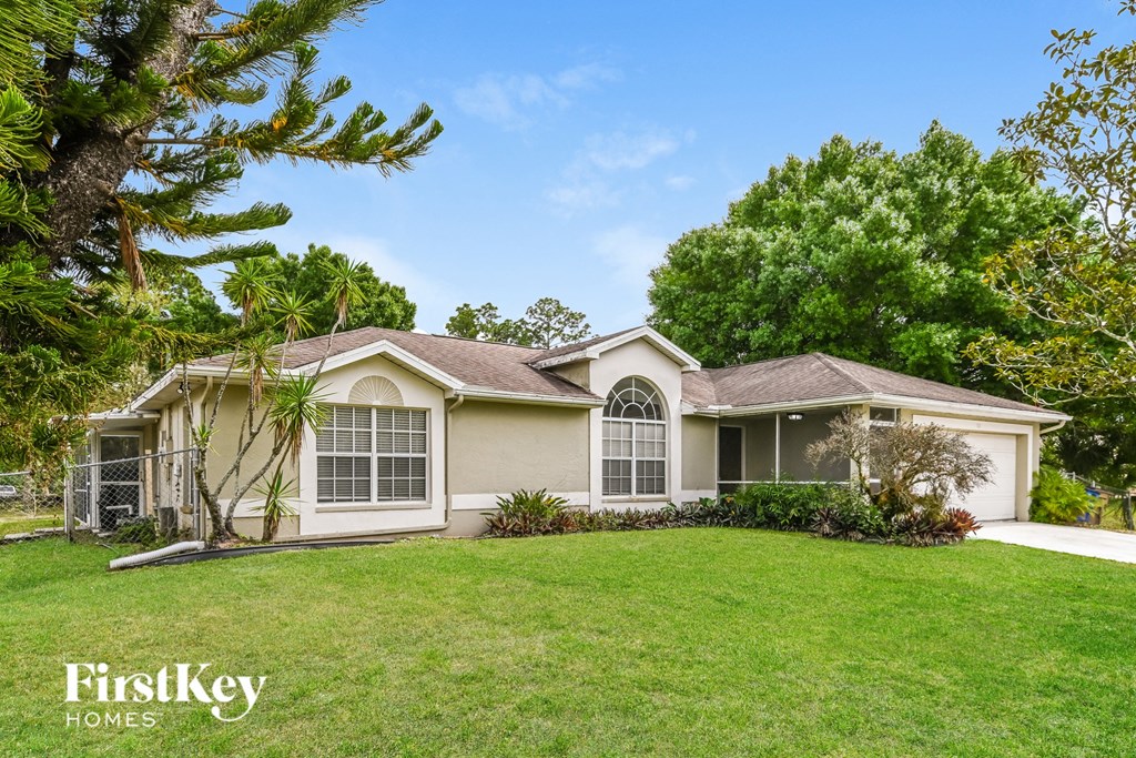 a home with a green lawn and trees