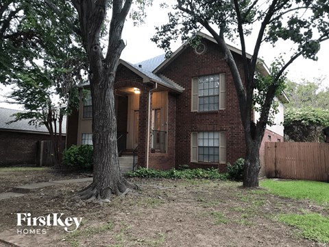 a house with two trees in front of it