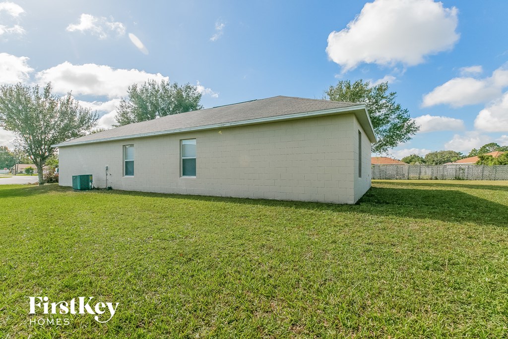 a small white house sitting in a grassy yard
