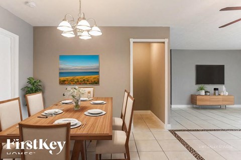 A dining room with a wooden table set for four.