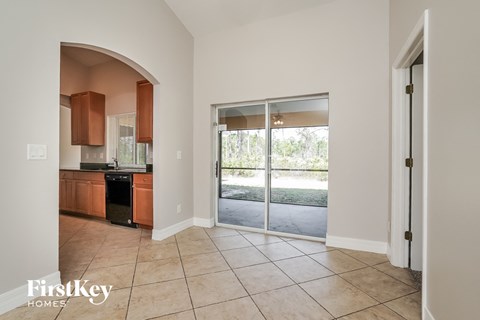 A kitchen area with a dishwasher and a sliding glass door leading to a backyard.