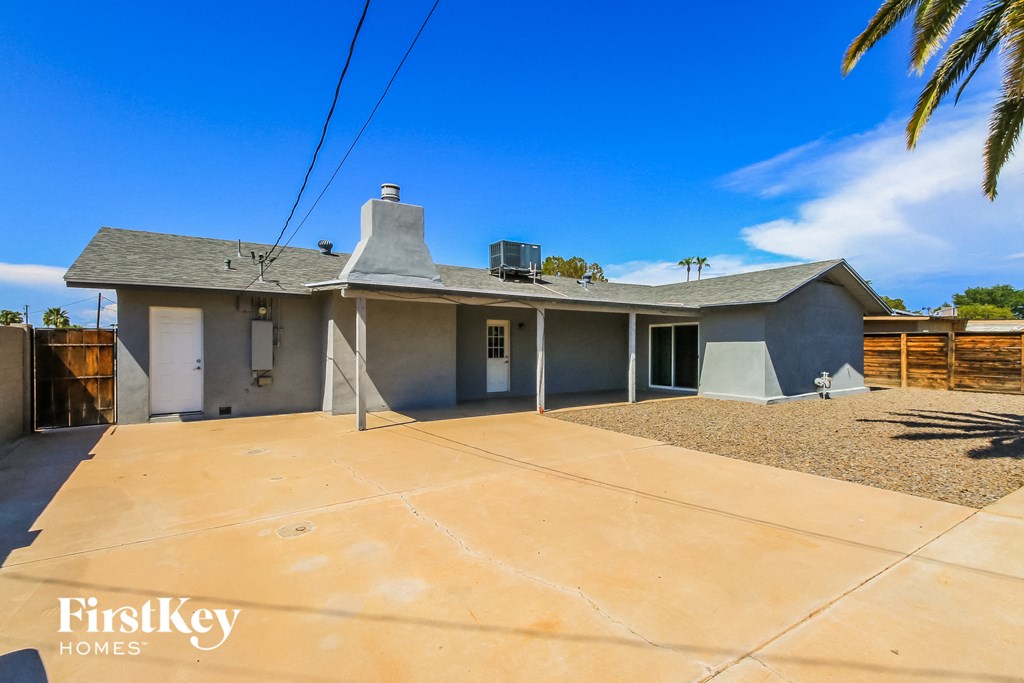 a white house with a driveway and a roof