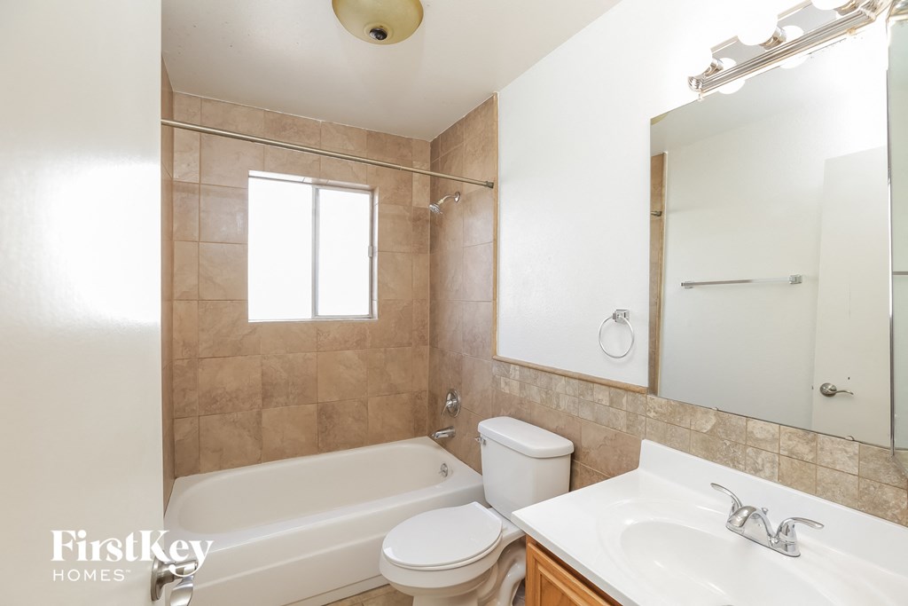 a bathroom with a sink toilet and a bath tub