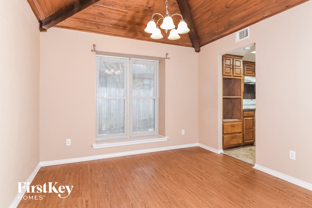 a living room with wood floors and a large window