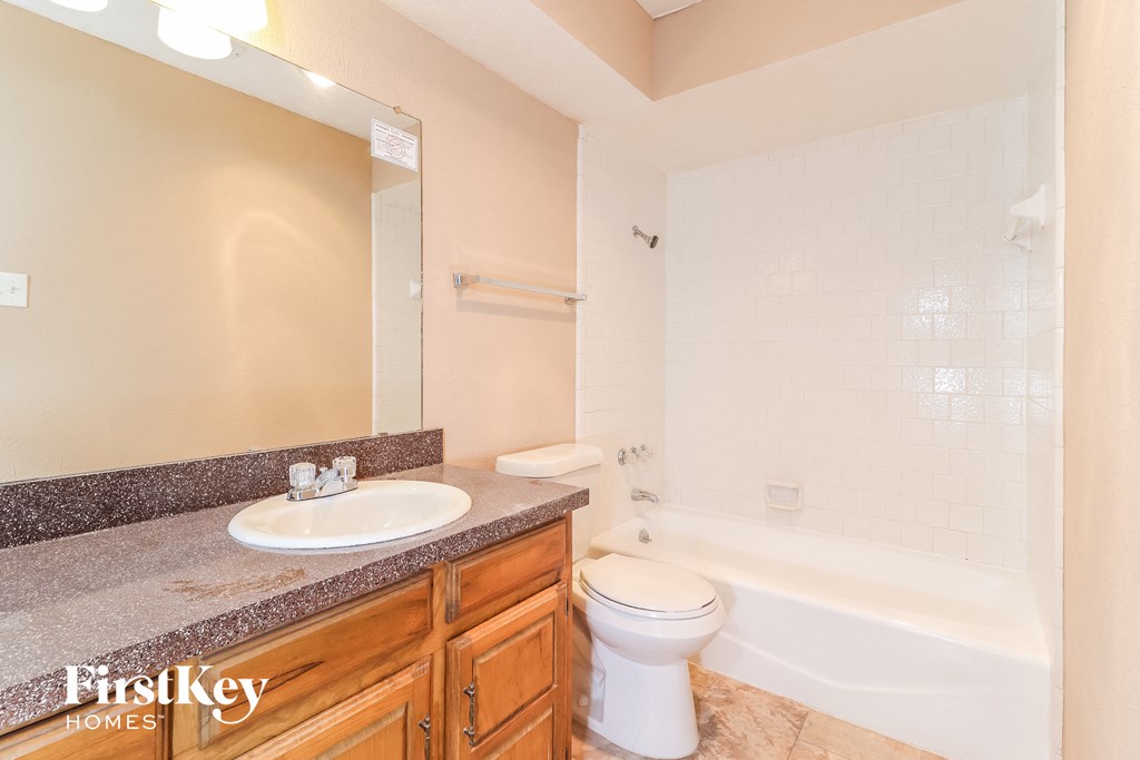 a bathroom with a sink toilet and a tub