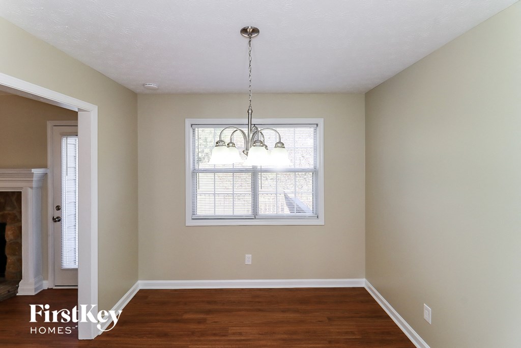 a dining room with a chandelier and a window