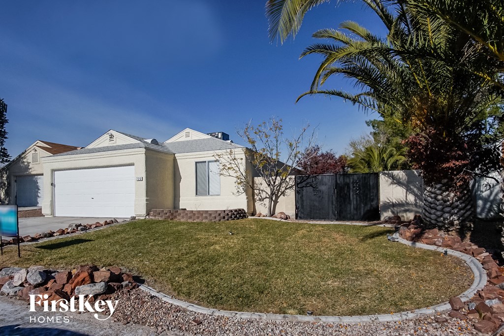 a house with a lawn and a palm tree