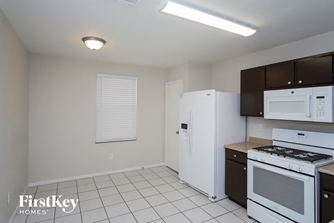 a kitchen with white appliances and black and white cabinets