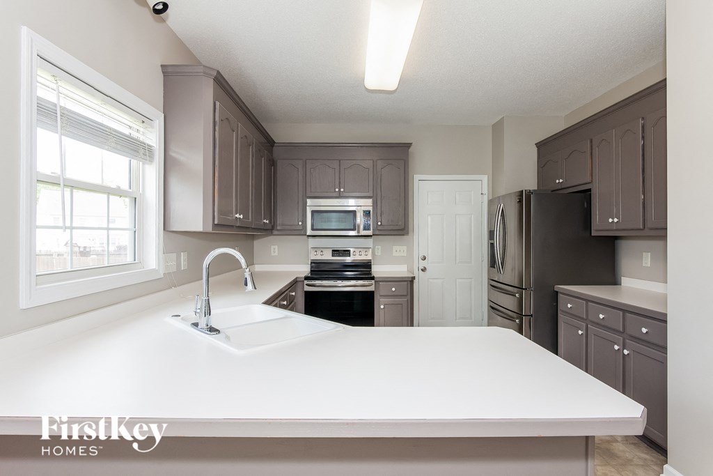 a kitchen with a large white counter top and a sink