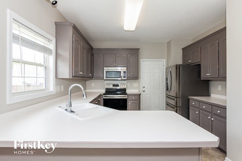 a kitchen with a large white counter top and a sink