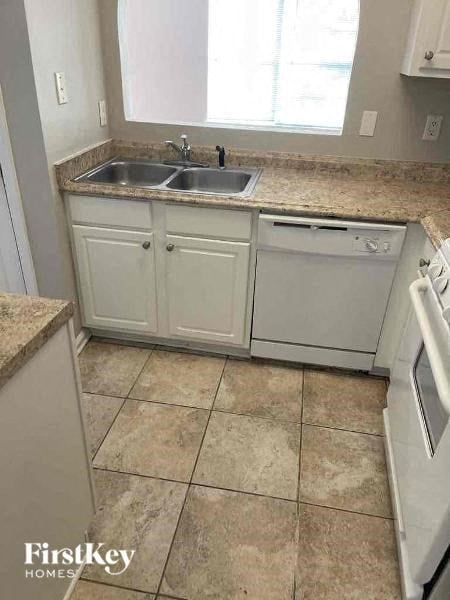a small kitchen with a sink and a dishwasher
