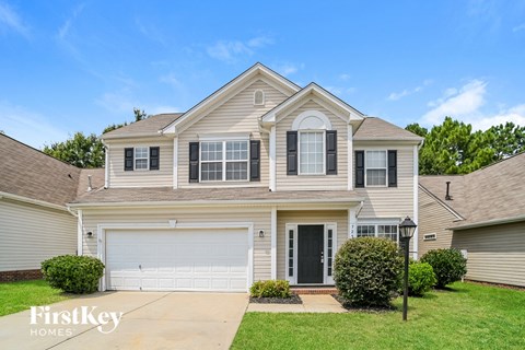 A two-story house with a garage is for sale.