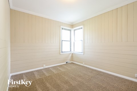 the living room of a home with a carpet and a window
