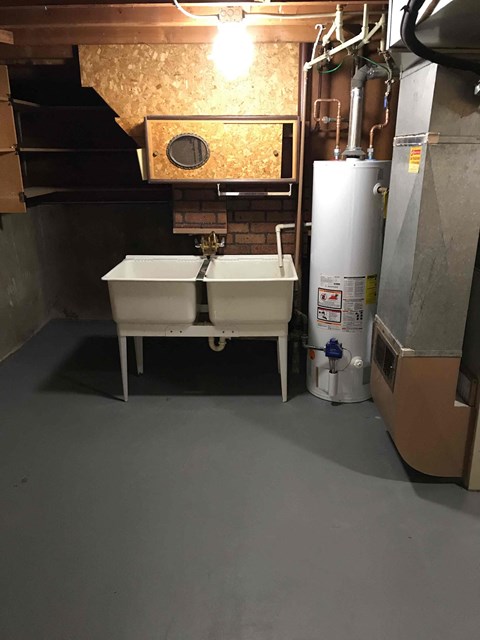 a kitchen with a sink and a stove in a small room