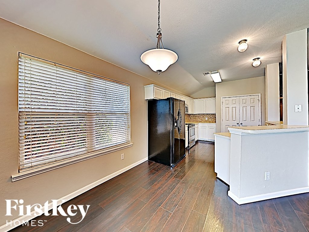 an open kitchen and living room with a large window