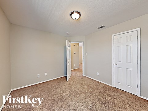 a bedroom with a closet and a door to a hallway