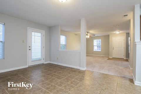 the living room and dining room of an empty house