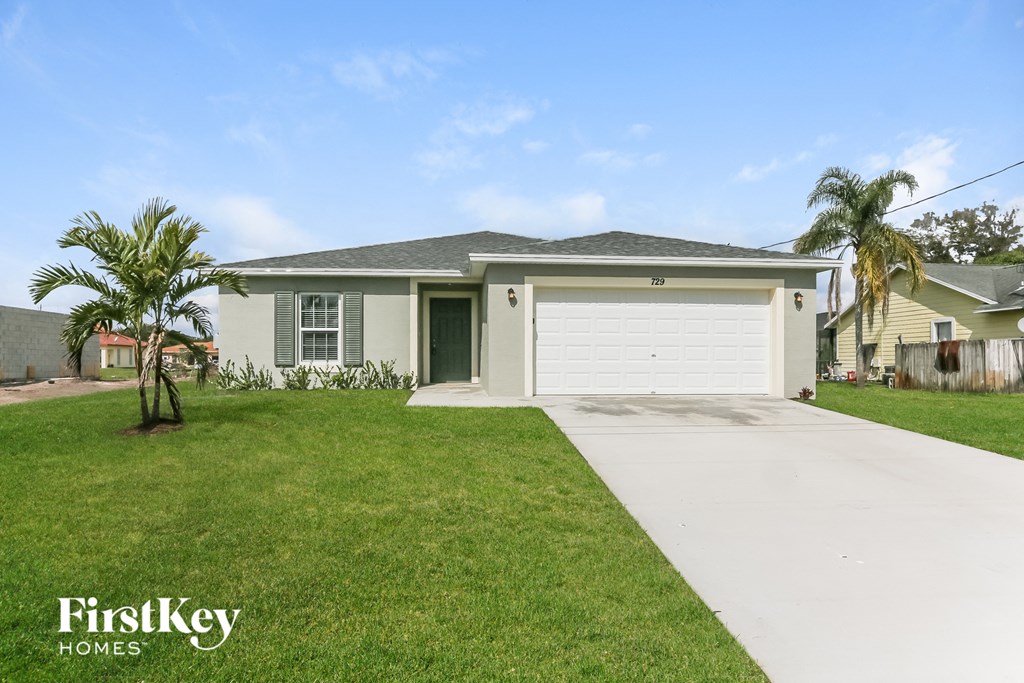 a house with a driveway and a lawn