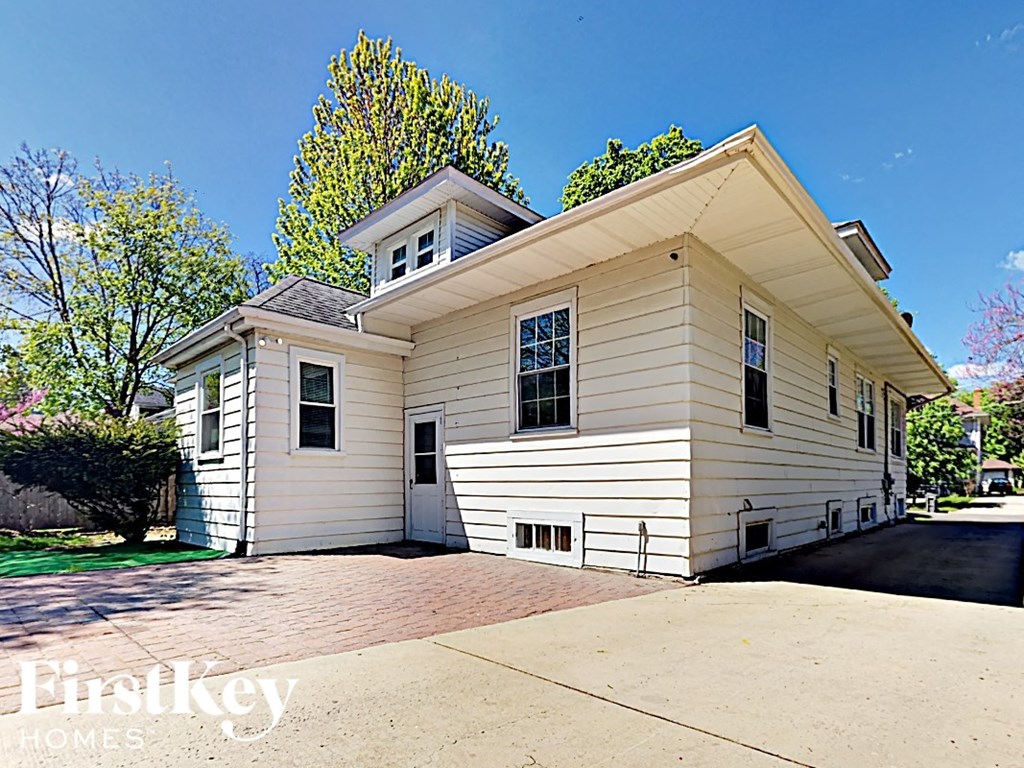 a white house with a driveway in front of it